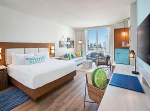 a bedroom with a large bed and a living room at Margaritaville Hotel Nashville in Nashville
