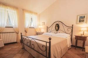 a bedroom with a bed in a room with windows at Agriturismo Villa Caterina in Levanto