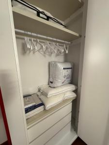 a closet with a washer and dryer and towels at La casa dei miei in Bologna