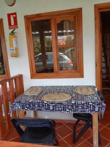 a table with two chairs in a room with a window at Sol y Luna Villa Campestre in Iza