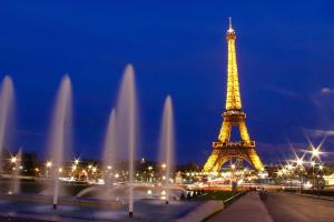 a view of the eiffel tower at night at Cocon moderne et cosy proche Disneyland et Paris in Torcy