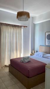 a bedroom with a bed with two towels on it at Harmonia Himara in Himare +23 photos