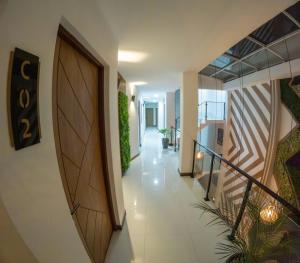 a hallway with a wooden door and a staircase at Bastille Hotel in Sucre