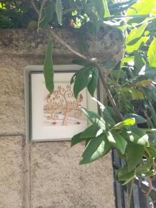 a picture of a tree in a picture frame on a wall at Casa dei glicini in Follonica