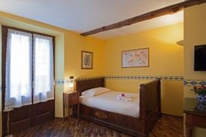 Postel nebo postele na pokoji v ubytování B&B Contrada dei Giardini