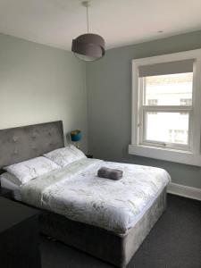 a bedroom with a large bed with a large window at The Old White Hart Brewery Guesthouse in Bath +39 photos