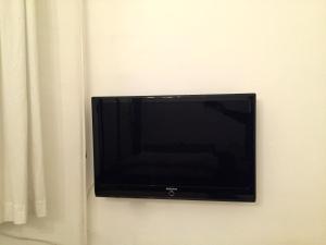 a flat screen tv hanging on a wall at Corso Apartment in Budapest
