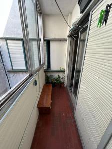 einen leeren Flur mit einer Bank und einem Fenster in der Unterkunft Departamento 1 dormitorio in Santa Fe