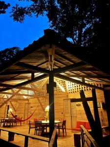 a wooden pavilion with tables and chairs on a deck at Kurrulau Hotel Playa Pacífica in Nabugá