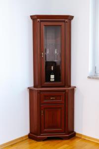 a wooden cabinet with a bottle of wine in it at Stan na dan Kvadar in Brčko