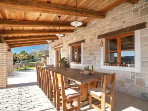 an outdoor dining room with a wooden table and chairs at Lavanda Mansion in Vodice