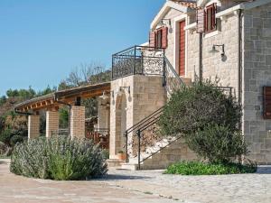 a stone building with a staircase and a balcony at Lavanda Mansion in Vodice