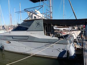 a white boat is docked in the water at Bateau au bassin des lumières in Bordeaux