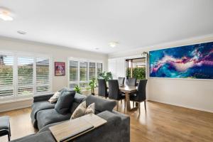 a living room with a couch and a table at Rowands Residence Mt Duneed in Mount Duneed +7 photos