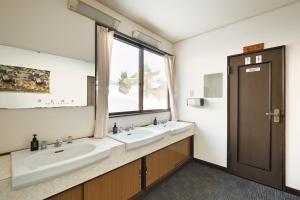 a bathroom with two sinks and a window at Iimori Vista in Hakuba +90 photos