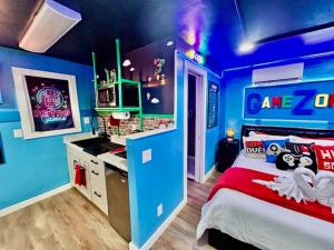 a blue room with a bed and a desk in it at GameZone in Sparks