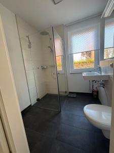a bathroom with a shower and a sink at Wohnung mit Garten und Whirlpool in Berlin