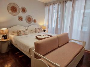 a bedroom with a white bed and a window at ASPA Studios - Urban Conscious Living in Funchal