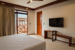 a bedroom with a bed and a flat screen tv at Cielo Bonito Hotel Boutique in Isla Aguada