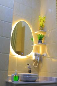 a bathroom with a sink and a mirror at Studio in the heart of Cairo in Cairo