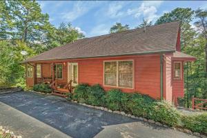 a red house with a driveway in front of it at Mountain Peace in Townsend