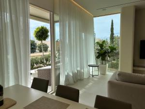 a living room with a couch and a large window at Villa Elodie, Green Coast, Palase in Palasë +27 photos