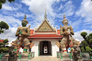 two statues standing in front of a building at ณัฐพิมลเพลส์ 3 in Bangkok Yai