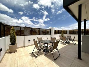 a patio with a table and chairs on a balcony at Cozy smart studio & home office in La Paz