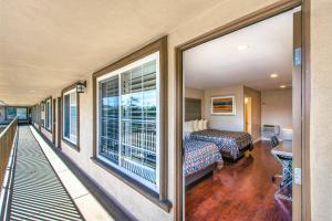 a hotel room with a balcony with a bed and a window at Hotel 414 Anaheim in Anaheim +37 photos