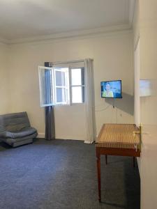 a living room with a couch and a tv on the wall at Studio in the heart of Cairo in Cairo