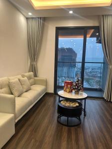 un soggiorno con un divano e un tavolo di Happy home stay a Hai Phong