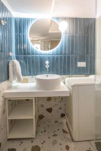a bathroom with a sink and a mirror at Alterra Vita Sea View Studio in Neos Marmaras