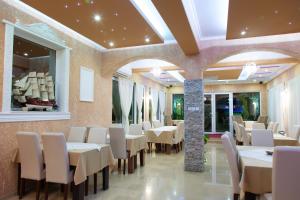 a dining room with white tables and chairs at "HOLIDAY" apartments & rooms in Ulcinj