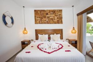 a bedroom with a bed with a heart made out of roses at Baliterraneo Boutique Resort in Seminyak