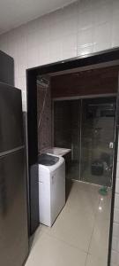 a small kitchen with a counter and a refrigerator at Casa por temporada em Garanhuns in Garanhuns +1 photo