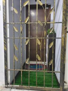 a window with a gate with gold leaves on it at Penginapan Puncak 28 in Kuala Terengganu +17 photos