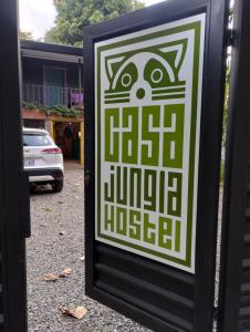 a sign with a picture of a cat on it at Casajungla Hostel in Jacó