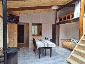 a dining room with a table and a stove at alojamientos CM in Tolhuin