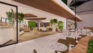ディーゲムにあるHilton Garden Inn Brussels Airportのテーブルと椅子のあるレストラン、キッチンが備わります。