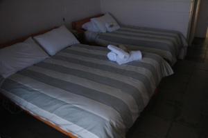 two beds with towels on them in a room at Otway Junction Motor Inn in Lavers Hill