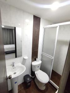 a bathroom with a toilet and a sink at Torre 2 Bucare in Yopal
