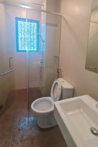 a bathroom with a toilet and a shower and a sink at NEW Condo Atlantis Melaka Town @ Memories in Melaka