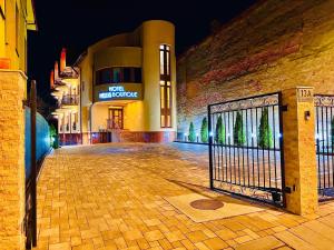 a gate in front of a building at night at Mellis Boutique in Cluj-Napoca