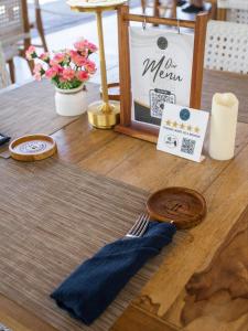 a table with a fork and a sign on it at Baliterraneo Boutique Resort in Seminyak
