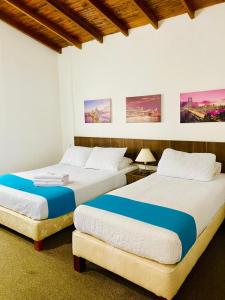 Postel nebo postele na pokoji v ubytování Hotel del Parque Confort LaCeja