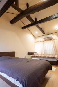 a bedroom with two beds and a window at 青海波 in Ine +12 photos