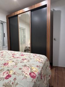 a bedroom with a bed with a floral bedspread at Hotel BEMMA in Mariscala