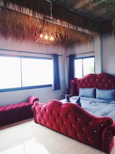 a bedroom with a large red bed and a couch at Exotic Koh Tao in Ko Tao +11 photos