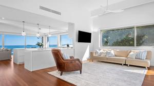 a kitchen and living room with a couch and a table at 'Sea Mist' by HolidayCo in Hardys Bay