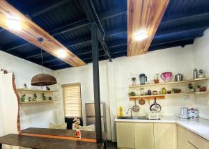 a kitchen with a wooden table and a sink at roc rach homestay in Ấp Tân Hà